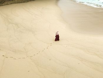 High angle view of woman walking on beach