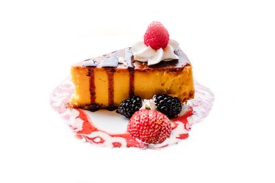 Close-up of strawberry cake against white background