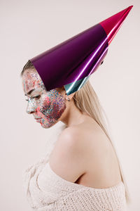 Portrait of beautiful woman with hat against white background