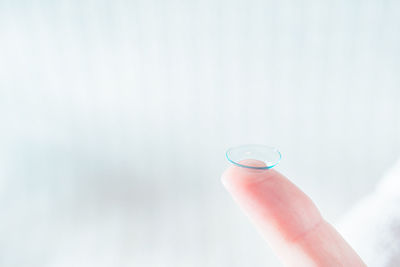 Close-up of hand holding water against blurred background