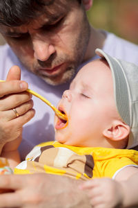 Close-up of father feeding son