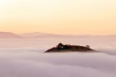 Scenic view of mountains against sky at sunset