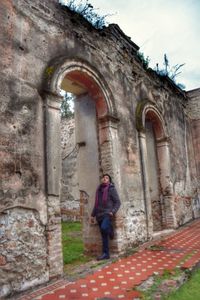 Full length of woman standing at historic building