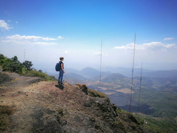 Man standing on mountain against sky