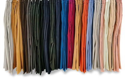 Full frame shot of multi colored clothes hanging against white background