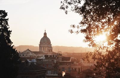 View of cathedral against sky in city at sunset