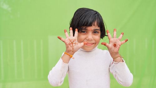 Cute little indian girl smiling cheerful showing number five with fingers. cute little girl having 