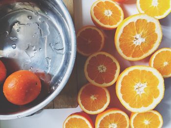 High angle view of orange slices by container on table