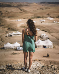 Rear view of woman standing on land