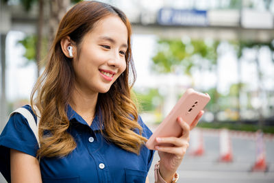 Young woman using mobile phone