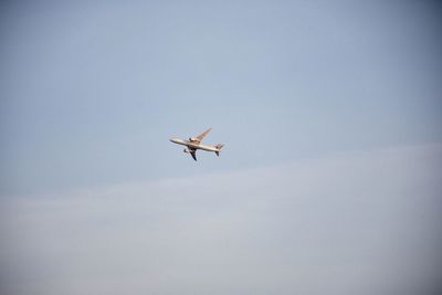 Low angle view of airplane flying in sky