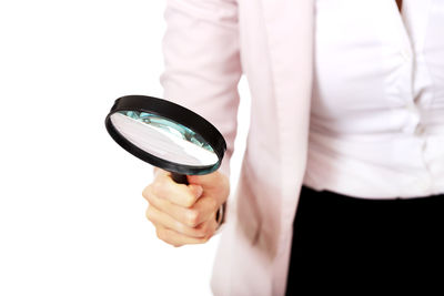 Close-up of woman holding hands over white background