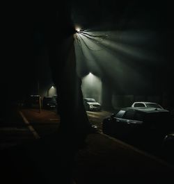 Silhouette of car on street at night