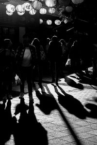 People walking on street in city at night