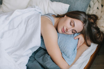 High angle view of woman lying on bed