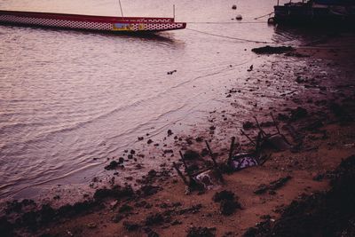 High angle view of boats moored at seashore during sunset