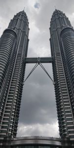 Low angle view of buildings against cloudy sky