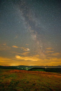 Scenic view of field against sky at night