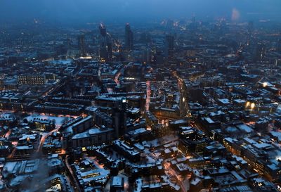 High angle view of city lit up at night