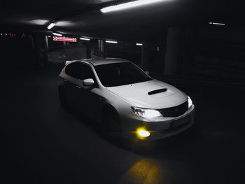 Illuminated cars in parking lot