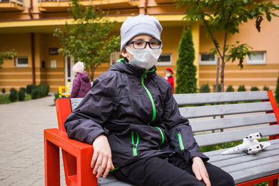 Portrait of man sitting on bench