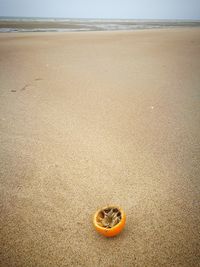 Sand on beach by sea against sky