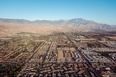 High angle view of city against clear blue sky