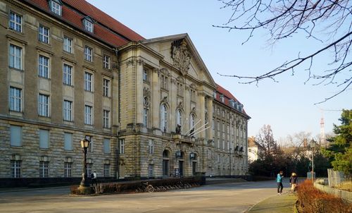 People in front of historical building in city