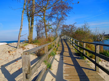 Boardwalk over baltic sea against sky
