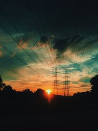 Silhouette trees against sky during sunset