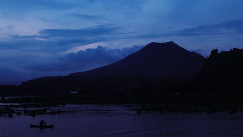 Scenic view of silhouette mountains against sky at night