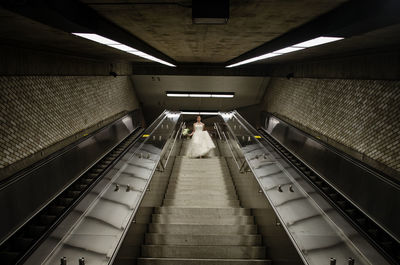 Low angle view of bride walking on steps