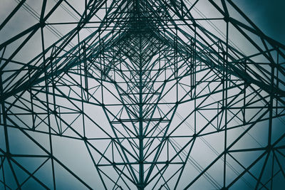 Directly below shot of electricity pylon against sky