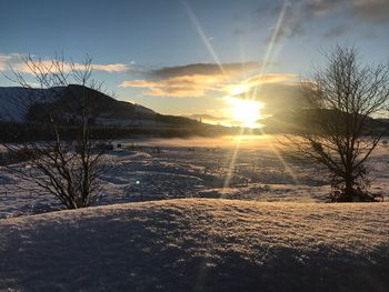 Scenic view of snow covered landscape during sunset