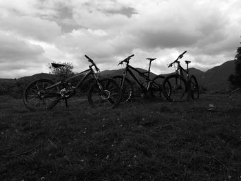 View of field against cloudy sky