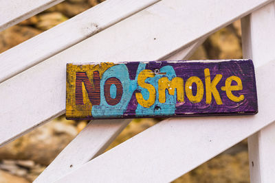 Close-up of text on metal railing