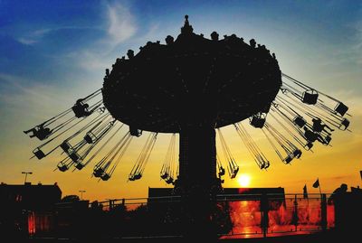 Low angle view of amusement park ride against sky