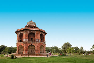 View of temple against clear blue sky