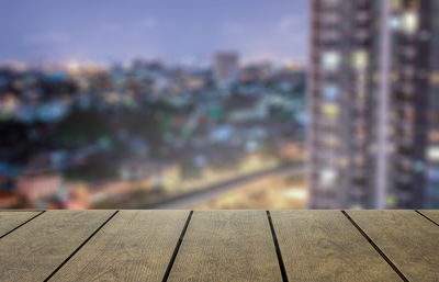 Close-up of railing against buildings in city