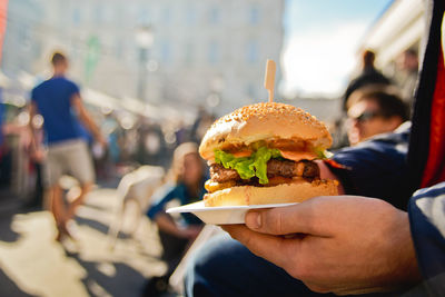 Close-up of man holding burger