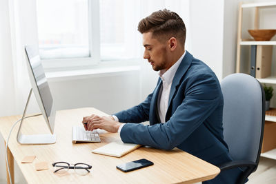 Side view of businessman working at office