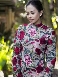 Portrait of young woman standing outdoors