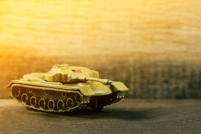 Close-up of toy military vehicle on wooden table