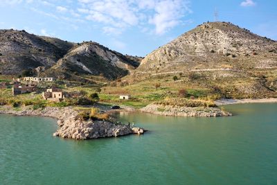 Panoramic view of lake and buildings against sky