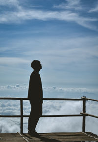 Silhouette man standing at observation point against sky
