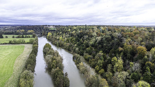 Panoramic shot of river amidst trees against sky