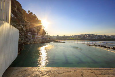 Scenic view of river against sky at sunset