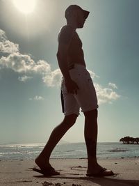 Side view of man standing on beach