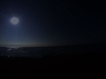 Scenic view of sea against sky at night