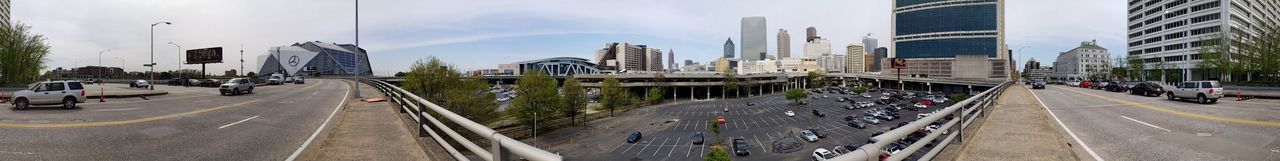 Panoramic view of city street and buildings against sky